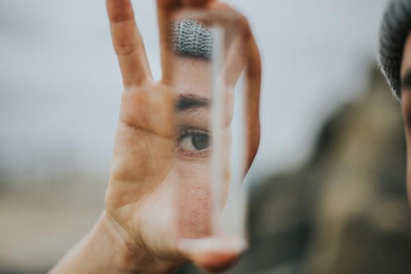 Discover true freedom with a soul retrieval, remote distance energy healing, power animal retrieval or guided journey with Shamanic Healer and Psychic Healing Medium, Tanya Morgan. This photo of a man holding a piece of mirror with his face reflected in it is by Vince Fleming on Unsplash.